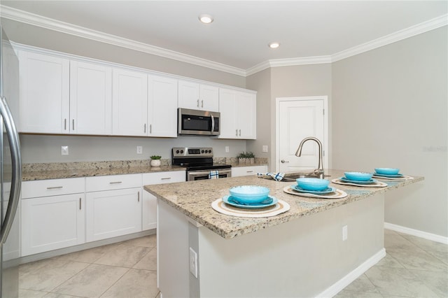 kitchen with an island with sink, a sink, white cabinetry, appliances with stainless steel finishes, and crown molding