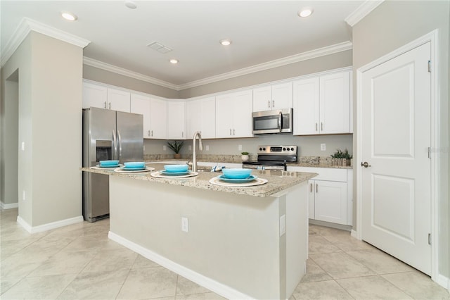 kitchen with stainless steel appliances, white cabinets, an island with sink, and sink