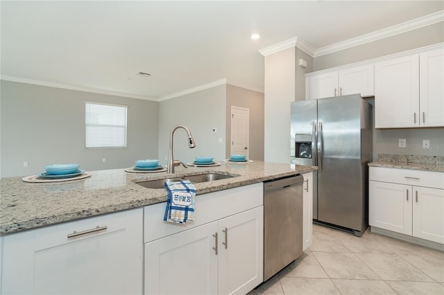 kitchen with light tile patterned floors, a sink, stainless steel appliances, white cabinets, and crown molding