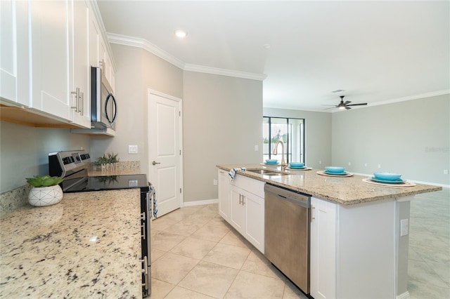 kitchen featuring white cabinetry, stainless steel appliances, a kitchen island with sink, and light stone countertops