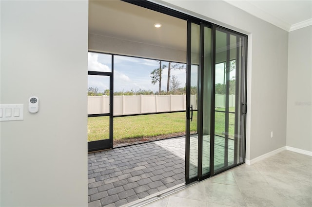 doorway with light tile patterned floors and crown molding