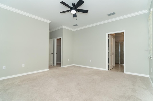 carpeted empty room with ceiling fan and crown molding