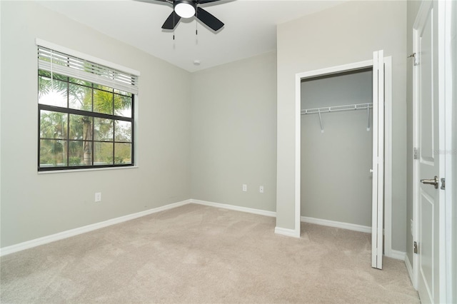 unfurnished bedroom with light colored carpet and ceiling fan