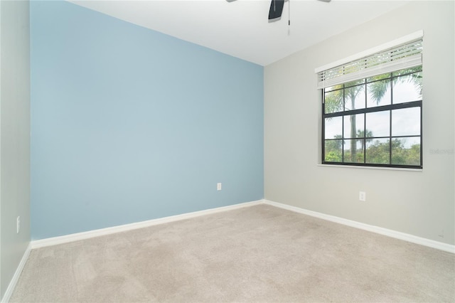 carpeted empty room featuring ceiling fan