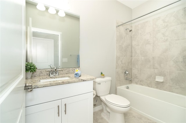 full bathroom with toilet, vanity, and tiled shower / bath