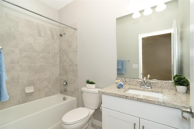 full bathroom featuring toilet, vanity, and tiled shower / bath