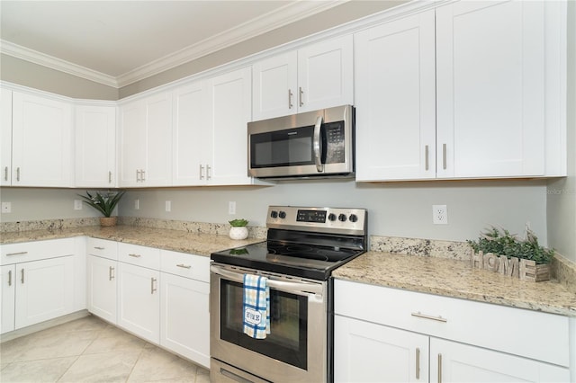 kitchen featuring light stone counters, stainless steel appliances, ornamental molding, and white cabinetry