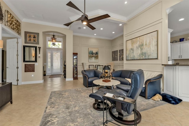 living room with ceiling fan, light tile patterned floors, and ornamental molding