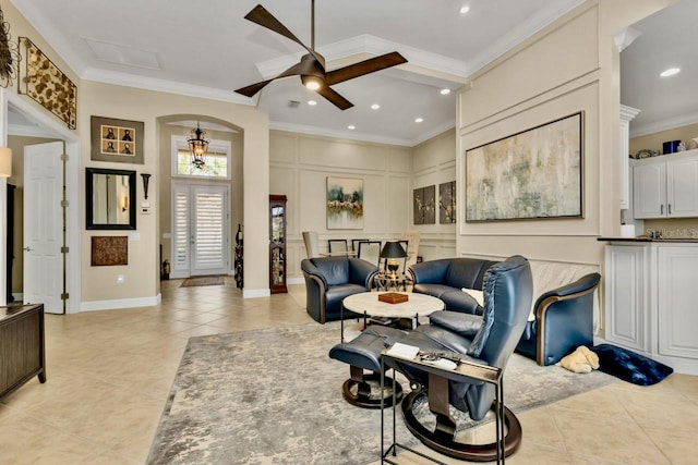 tiled living room featuring ornamental molding and ceiling fan