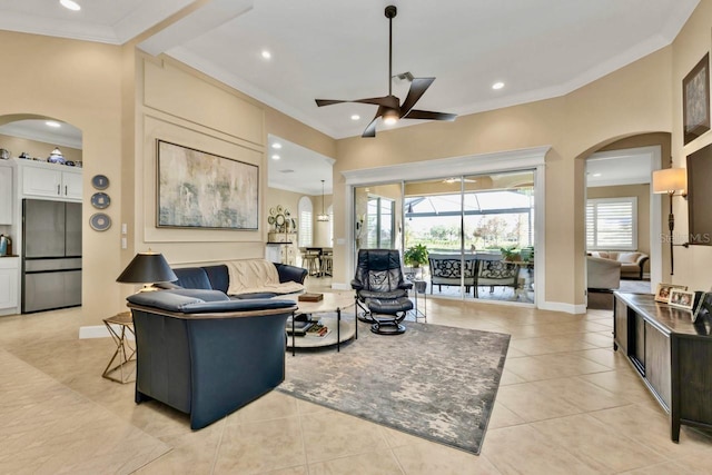 living room with light tile patterned flooring, ceiling fan, and ornamental molding