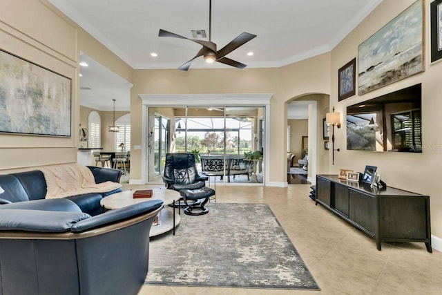 living room with ornamental molding, ceiling fan, and light tile patterned floors