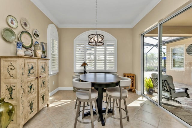 tiled dining room featuring ornamental molding and a notable chandelier