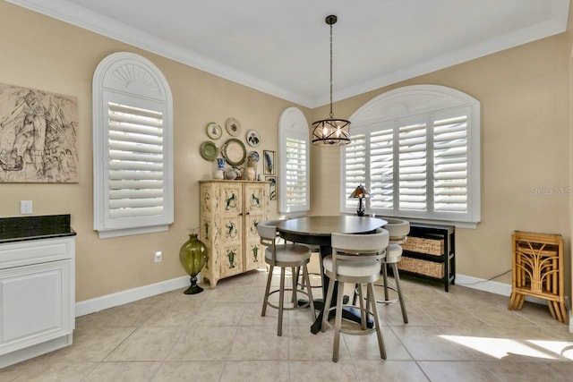 dining room with an inviting chandelier, light tile patterned floors, ornamental molding, and plenty of natural light