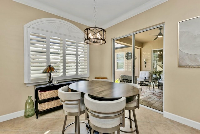 dining area with ceiling fan with notable chandelier, light tile patterned floors, and ornamental molding