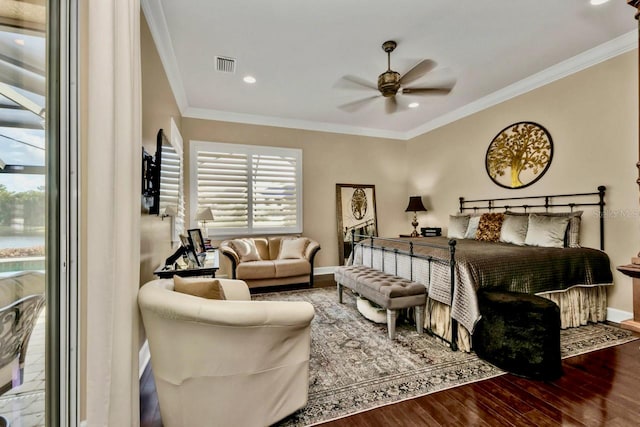 bedroom featuring hardwood / wood-style floors, ceiling fan, and ornamental molding