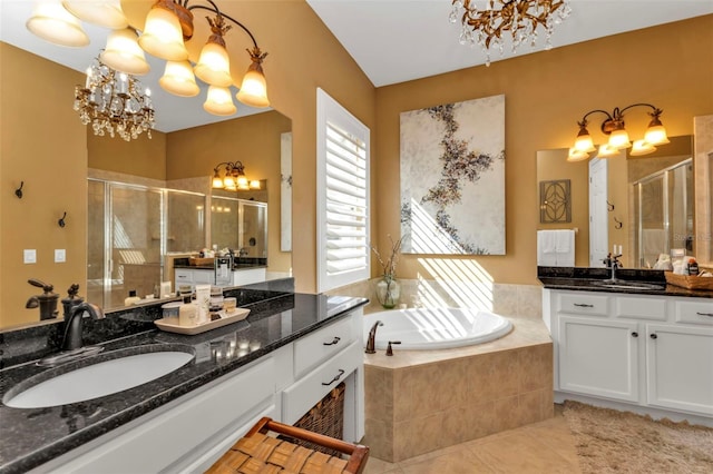 bathroom with tile patterned floors, independent shower and bath, vanity, and a notable chandelier