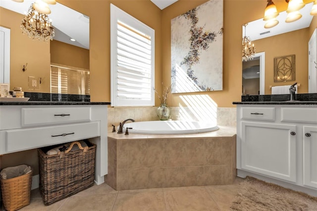 bathroom featuring vanity, tile patterned floors, plus walk in shower, and a notable chandelier