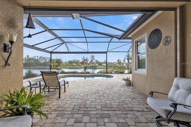 view of patio / terrace with a lanai and a water view