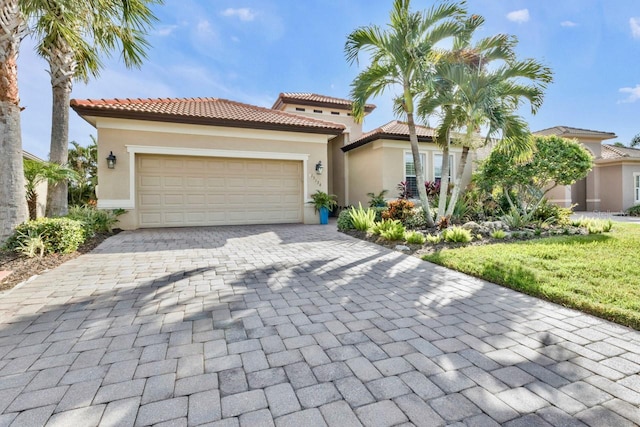 mediterranean / spanish-style home featuring a garage and a front yard