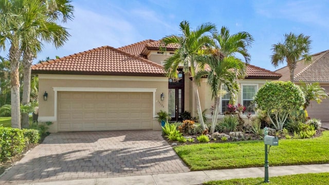 mediterranean / spanish-style home with a garage