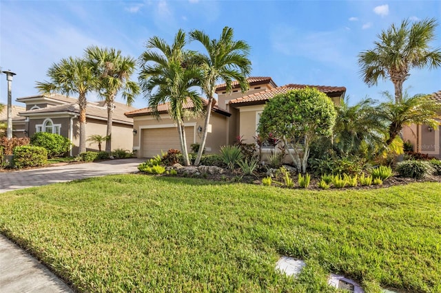 mediterranean / spanish home with a garage and a front yard