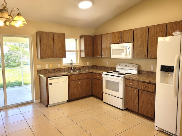 kitchen with lofted ceiling, white appliances, sink, and a wealth of natural light