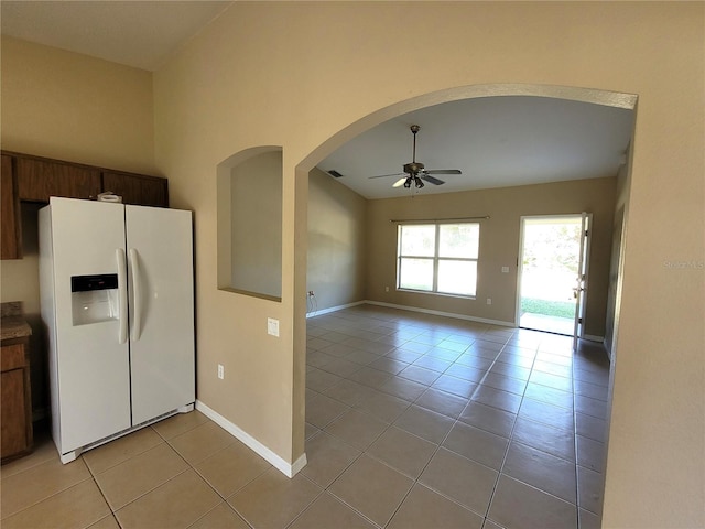 kitchen featuring ceiling fan, light tile patterned floors, and white refrigerator with ice dispenser