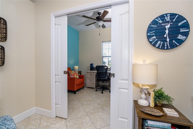 office area with light tile patterned floors and ceiling fan