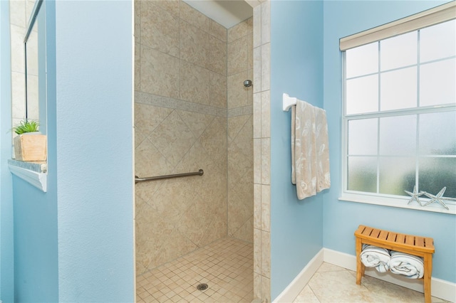 bathroom with tile patterned floors and a tile shower