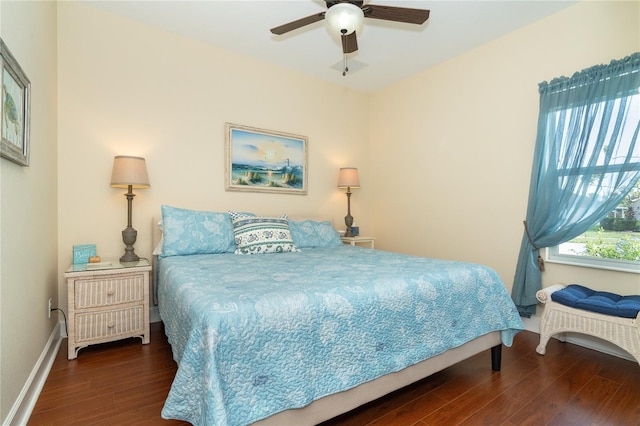 bedroom with dark hardwood / wood-style flooring and ceiling fan