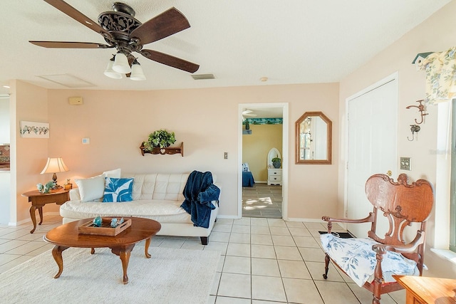 living room featuring ceiling fan and light tile patterned floors