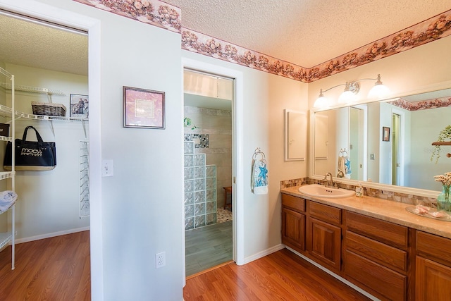 bathroom featuring a textured ceiling, vanity, and hardwood / wood-style floors