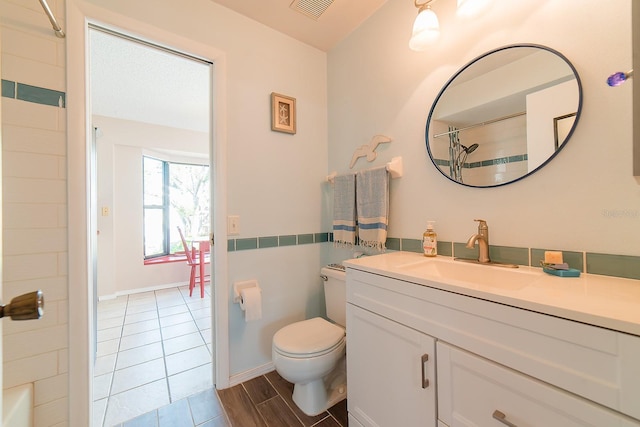 bathroom featuring toilet and vanity