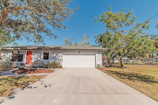 view of front of property with a garage and a front lawn