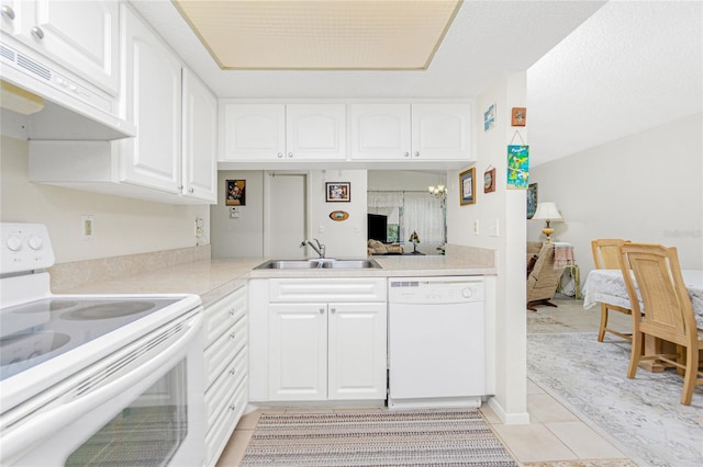 kitchen featuring white appliances, extractor fan, sink, and white cabinetry