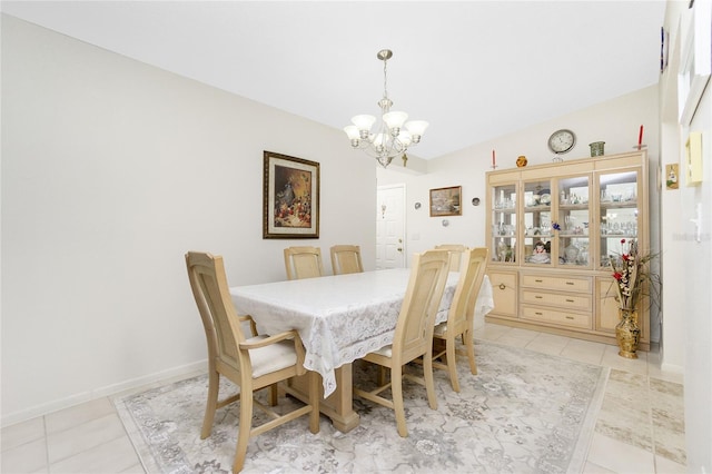 dining room with light tile patterned floors and a chandelier