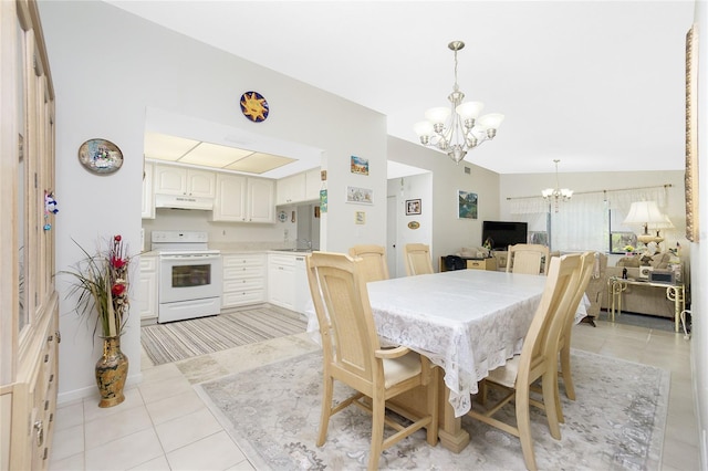 tiled dining area featuring sink, lofted ceiling, and a notable chandelier