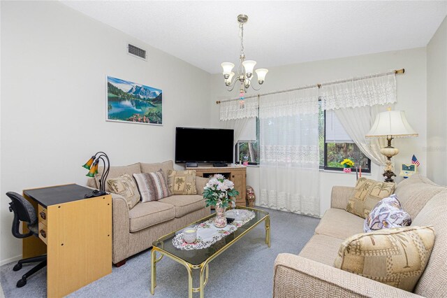 living room featuring carpet floors and a notable chandelier