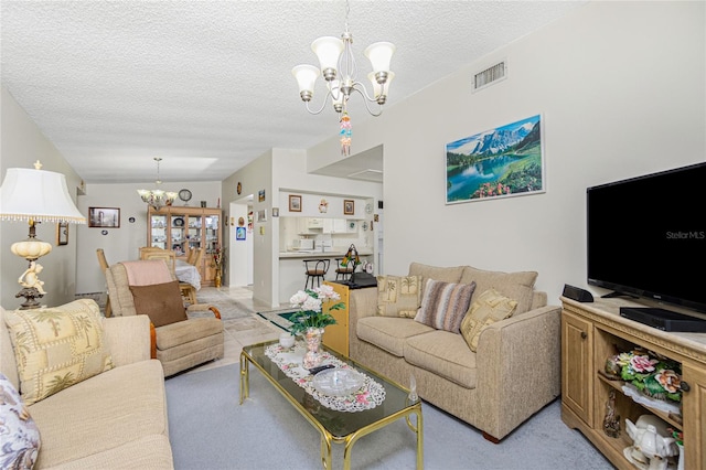 carpeted living room featuring a textured ceiling and an inviting chandelier