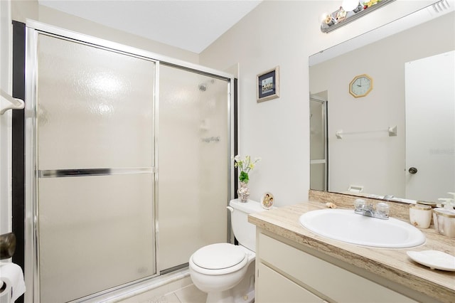 bathroom with tile patterned flooring, an enclosed shower, vanity, and toilet