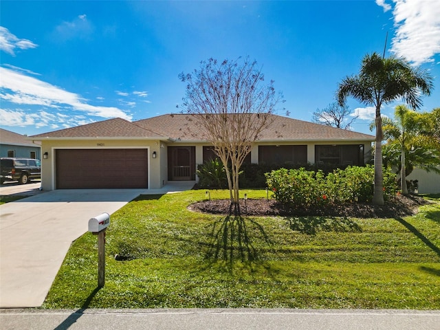 single story home with a front yard and a garage