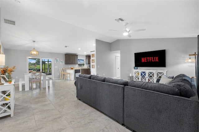 living room with ceiling fan and lofted ceiling