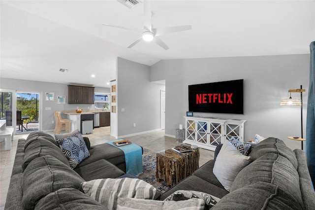 living room featuring ceiling fan and lofted ceiling