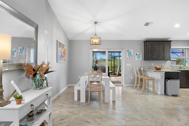 dining area with sink and vaulted ceiling