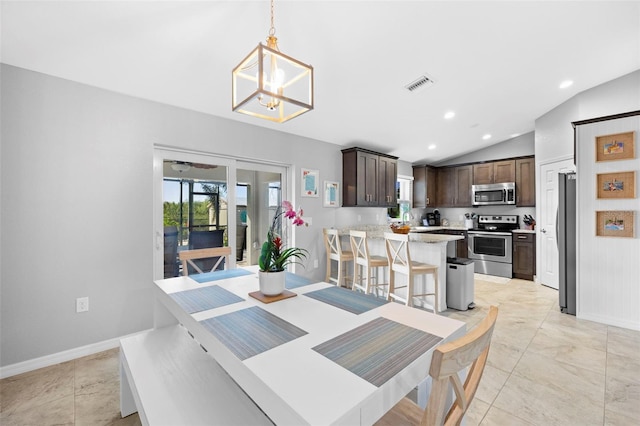 dining room featuring lofted ceiling and a notable chandelier