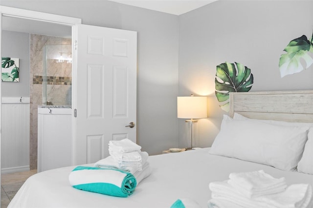 tiled bedroom featuring ensuite bath