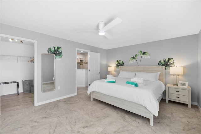 bedroom with ceiling fan and ensuite bath