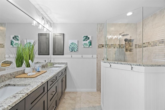 bathroom with vanity and a tile shower