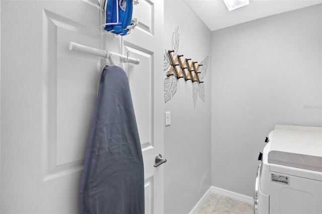 laundry area featuring separate washer and dryer and light tile patterned floors