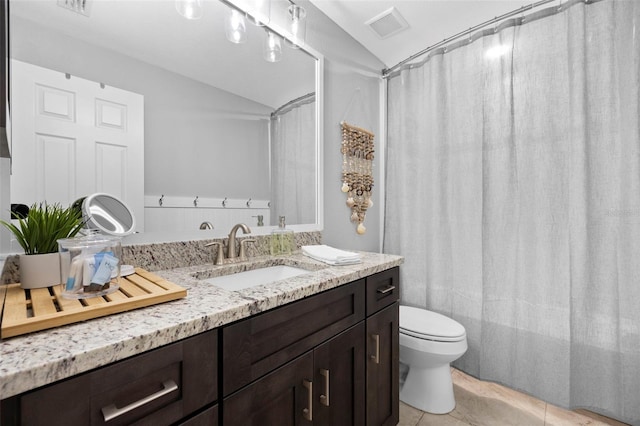 full bathroom featuring tile patterned floors, shower / tub combo with curtain, vanity, and toilet